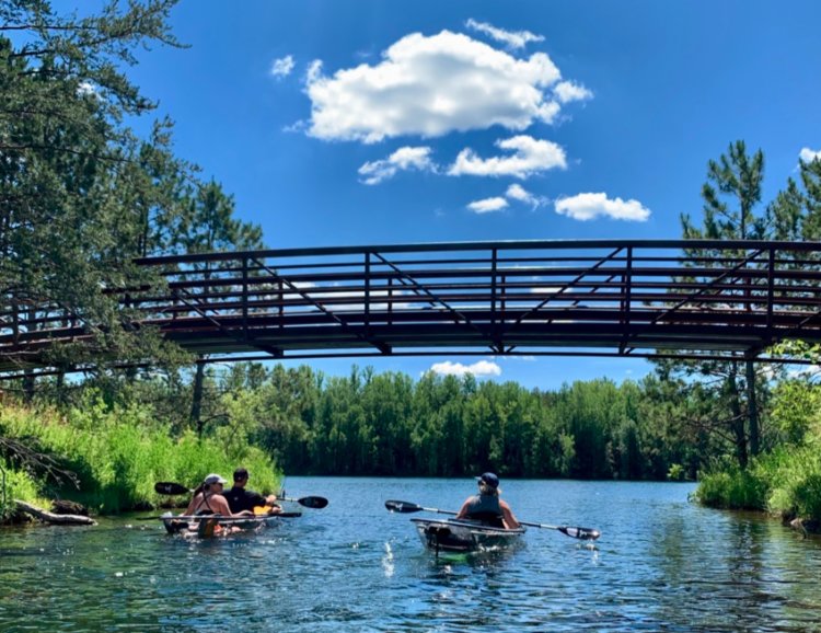 Kayaking clear lake waters in Cuyuna