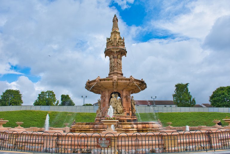 The ornate Victorian ceramic fountain with the People's Palace behind