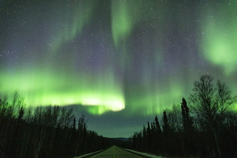 Several bands of aurora borealis dancing over Poker Flats