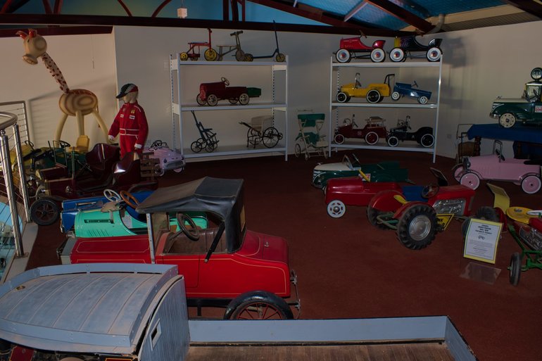 The floor is full of cars and the mezzanine full of motorbikes and old toys including handmade
