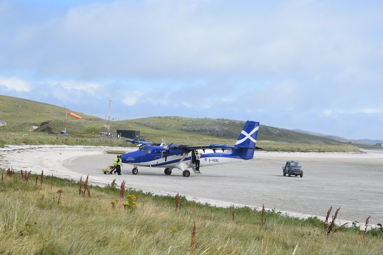 The plane lands at Barra 'Airport'.
