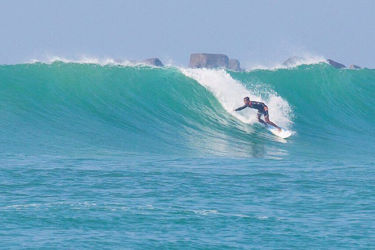 A surfer in Weligama