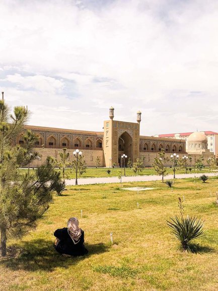 An Uzbek lady rests in the shade of a tree at the Jami Madrasah, Andijan.