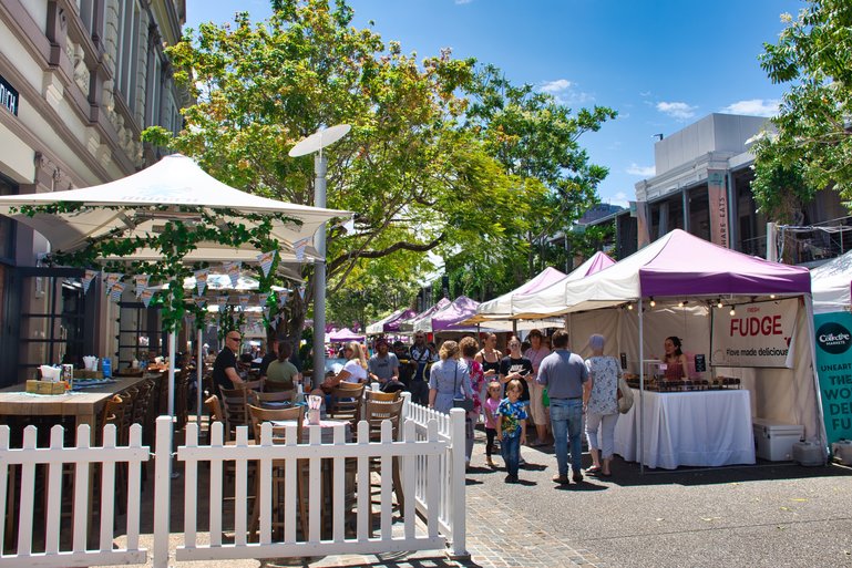 Markets line one side and restaurants and cafes on the other