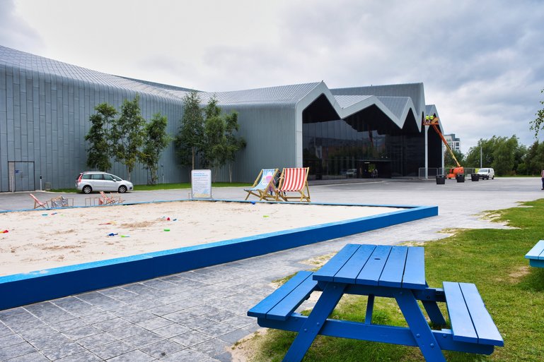 The entrance to the Riverside Museum with sandpit and picnic tables for families