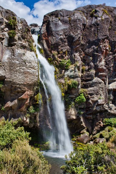 The beautiful Taranaki Falls falling into the pool below that you can swim in