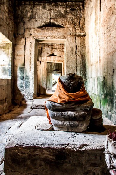 A draped statue in the corridors of Ta Prohm