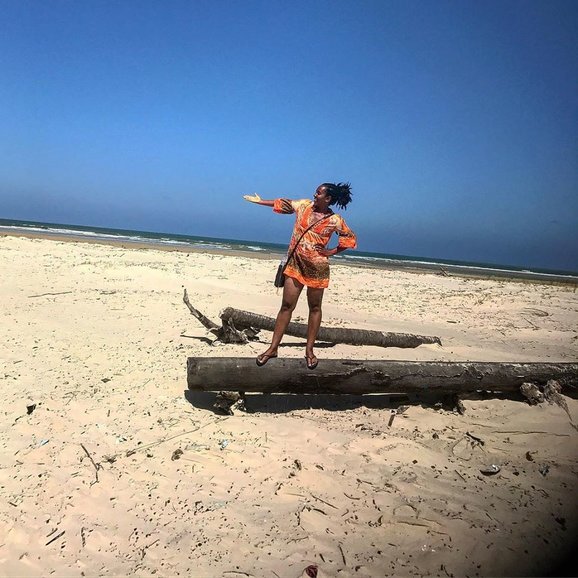 Jennifer Manzanillo on a tree log in Betania Island