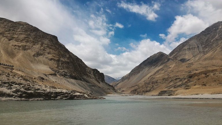 Tall mountains slope down to the rivers 