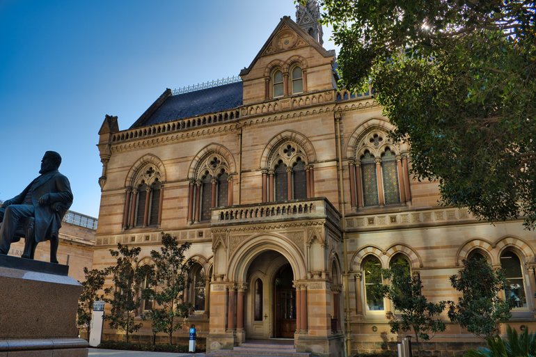 A University of Adelaide building with its founder's statue in front, Sir Walter Watson Hughes