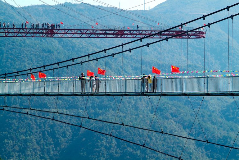 The glass bridge in the foreground, the glass platform in the background