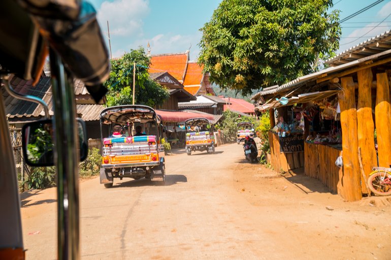 CONVOY THROUGH A  VILLAGE