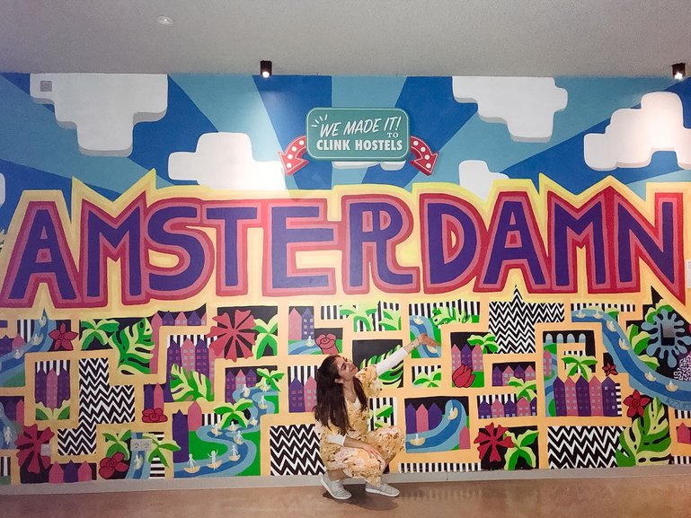 In front of a fun artsy wall at my hostel, ClinkNOORD, in Amsterdam!