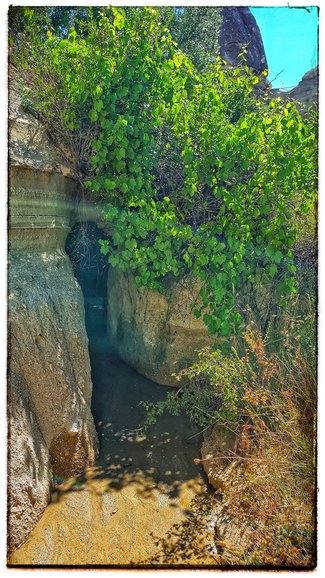 Narrow gully alongside the path