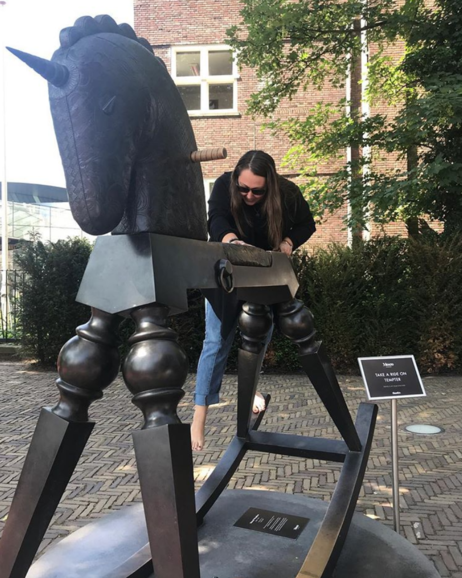 Here is a picture of me struggling to climb onto a Banksy sculpture!