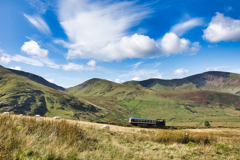 The train is heading up Mt. Snowdon near the track