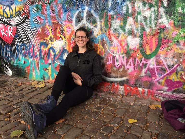 Cheery in front of the Lennon Wall in Prague