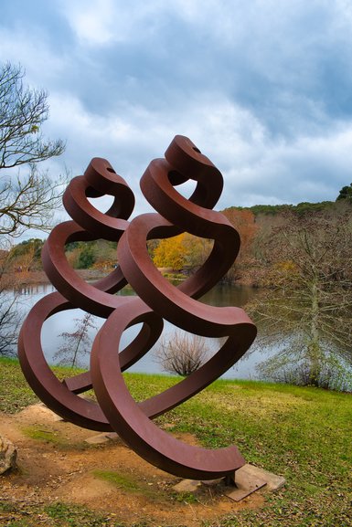 Sculptures are dotted around, especially beside the lake