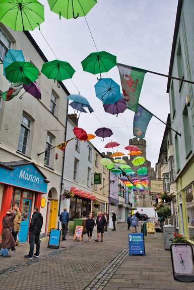 One of the colourful streets due to the umbrellas strung up along the skyline leading to the Castle