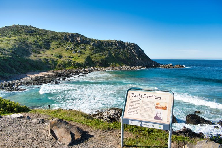 Petrel Cove with one of the many information boards along the trail